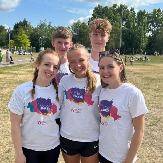 a photo of a group of students who are senior leaders helping out at an event